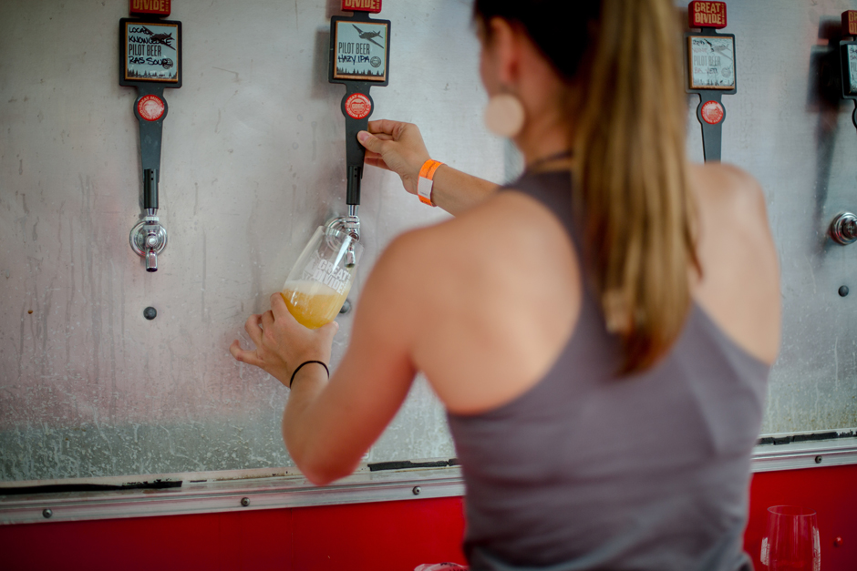 pouring a beer at great divide block party